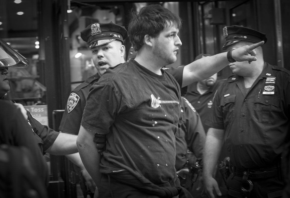 Occupy Wall Street NYPD Officer leading arrested protester